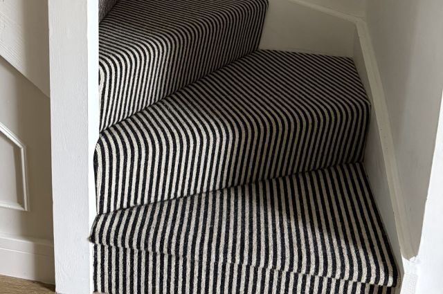 black and white cream striped stairs carpet on curved staircase